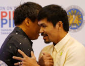 Newly elected senators Philippine boxing star Manny Pacquiao (R) and Joel Villanueva congratulate each other after being declared by elections officials as new members of the upper house of Congress in Manila, Philippines May 19, 2016. REUTERS/Erik De Castro