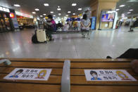 Social distancing signs are seen on a chair to help stop the spread of coronavirus at Seoul Railway Station in Seoul, South Korea, Monday Aug. 31, 2020. South Korea has counted its 18th straight day of triple-digit daily jumps in coronavirus cases as its health minister warned about an increase in transmissions gone untraced. The signs read: "Leave one seat." (AP Photo/Ahn Young-joon)