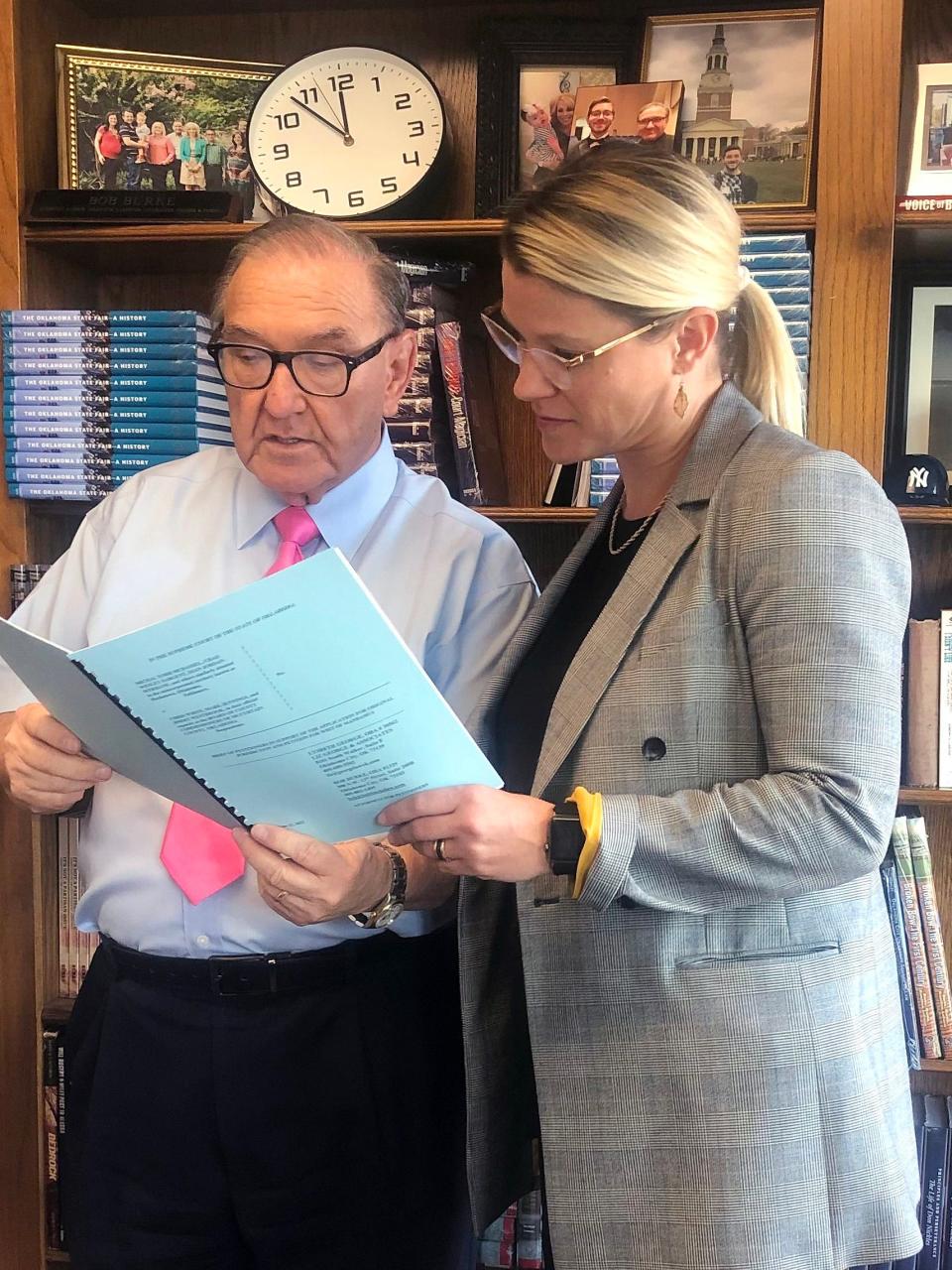 Bob Burke in his office with attorney Lysbeth George discussing an Oklahoma Supreme Court case.