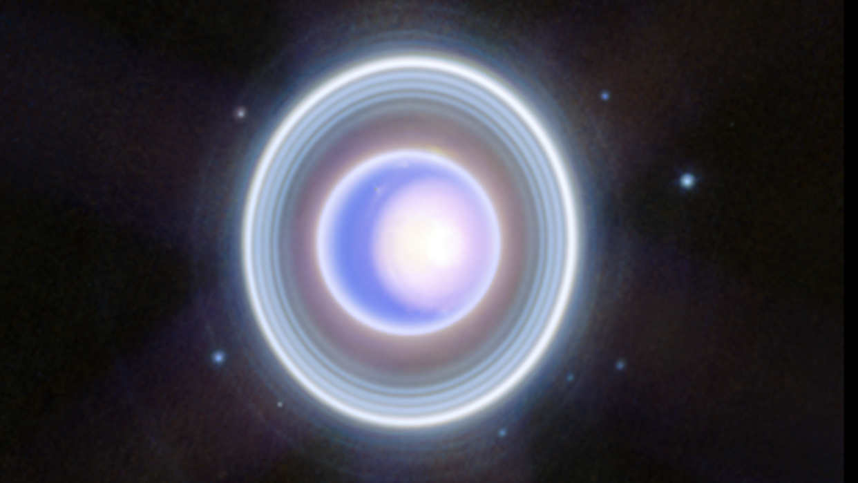  A purple sphere surrounded by alternating white and blue bands and an oter white band against a black background. 