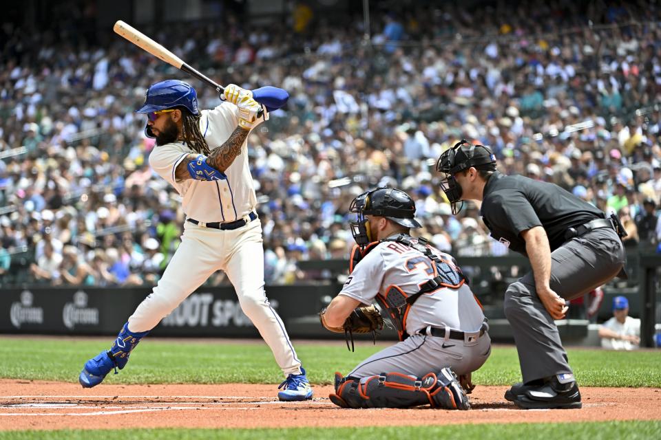 J.P. Crawford of the Seattle Mariners bats, Jake Rogers #34 of the Detroit Tigers catches during the first inning at T-Mobile Park on July 16, 2023 in Seattle, Washington.