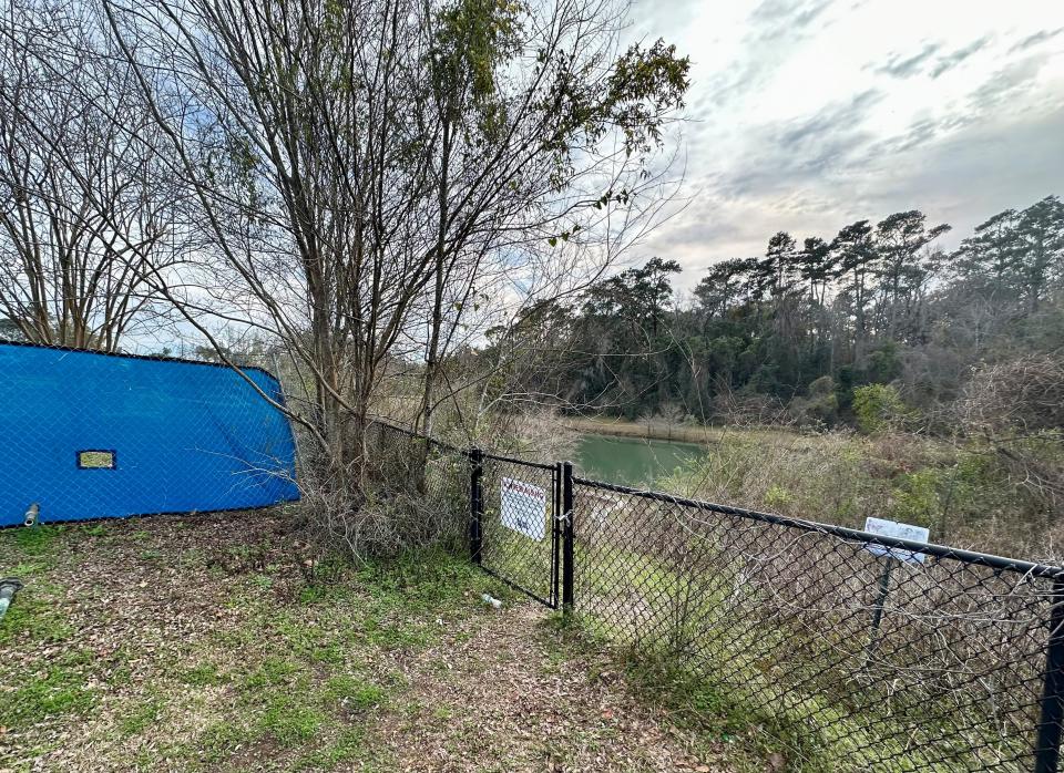 Pictured above is a chain link fence partially surrounding a stormwater pond adjacent to the site of the future Tallahassee Police Department headquarters, which is surrounded by a larger fence with a blue privacy screen. The no trespassing sign on the smaller fence, the privacy screen and other warnings were added after County Commissioner David O'Keefe, City Commissioner Jeremy Matlow and others visited the area, Matlow told the Democrat.