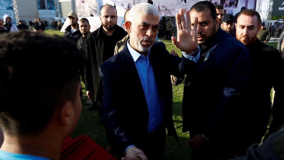 File photo of Hamas leader Yahya Sinwar shaking hands with a man during a rally in Gaza on April 14, 2023