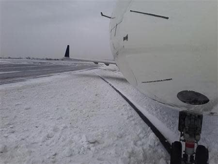 A plane is seen after it skidded off a runway after landing at John F. Kennedy International Airport in this picture provided by NBC 4 January 5, 2014. A plane taxiing after landing skidded off a runway at John F. Kennedy International Airport and slid into snow on Sunday, federal officials said. No injuries were reported. REUTERS/NBC 4 New York/Handout via Reuters