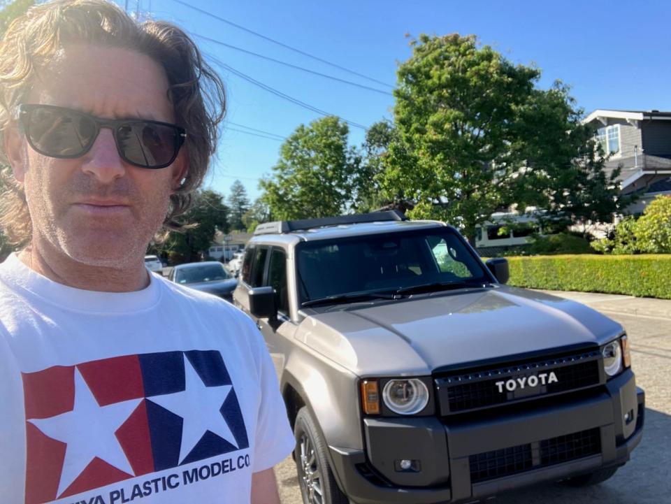 A Business Insider journalist stands near the 2024 Toyota Land Cruiser