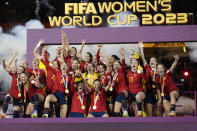 Team Spain celebrates with the trophy after winning the Women's World Cup soccer final against England at Stadium Australia in Sydney, Australia, Sunday, Aug. 20, 2023. (AP Photo/Alessandra Tarantino)