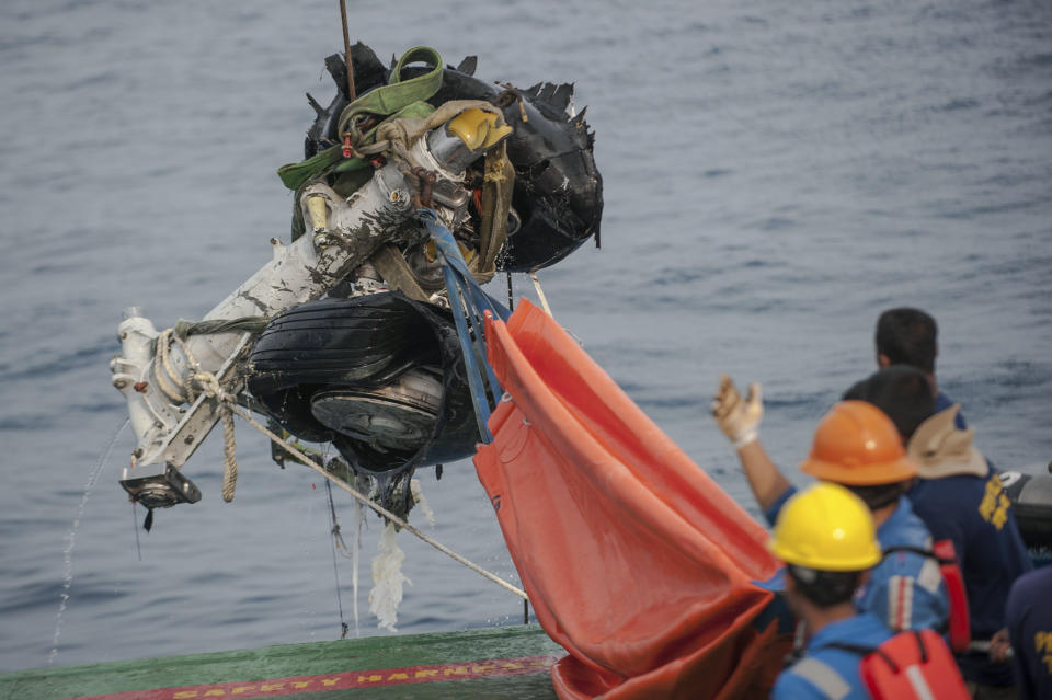 Rescuers use crane to retrieve part of the landing gears of the crashed Lion Air jet from the sea floor in the waters of Tanjung Karawang, Indonesia, Sunday, Nov. 4, 2018. Investigators succeeded in retrieving hours of data from the aircraft's flight recorder as Indonesian authorities on Sunday extended the search at sea for victims and debris. (AP Photo/Fauzy Chaniago)