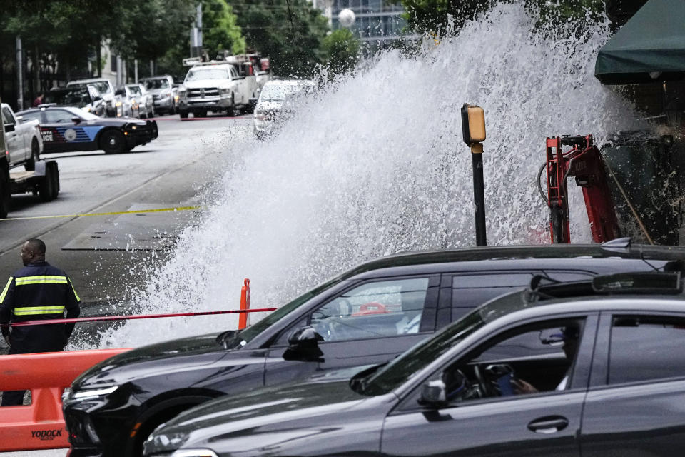 Water gushes out of a broken water transmission line in downtown Atlanta, Saturday, June 1, 2024. Much of Atlanta, including all of downtown, has been without water since Friday afternoon after crews began work to repair breaks on transmission lines in the downtown area. (AP Photo/Mike Stewart)