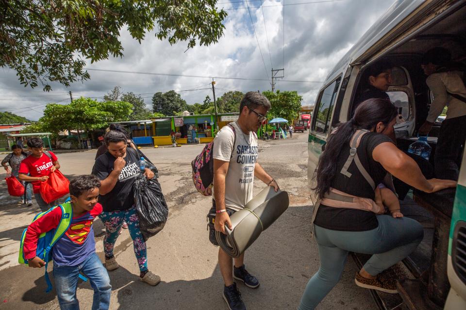 A Venezuelan family gets on public transportation just a few hundred yards from an immigration checkpoint north of Tapachula.