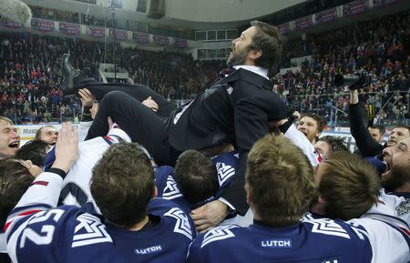 Ice Hockey - CSKA Moscow v Metallurg Magnitogorsk - Kontinental Hockey League - Gagarin Cup Grand Final, Game 7 - Moscow, Russia - 19/04/16 Metallurg Magnitogorsk's players and coach Ilya Vorobyov (top) celebrate their victory. REUTERS/Maxim Shemetov