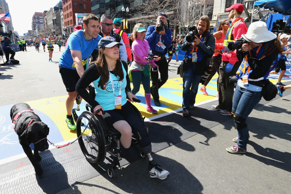 Downes and Kensky celebrate at the finish line with their dog after Downes completed the 120th Boston Marathon&nbsp;in 2016. (Photo: Maddie Meyer / Getty Images)