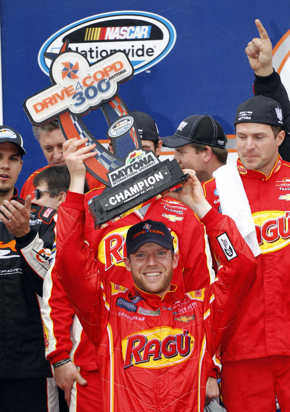 Regan Smith raises the trophy in Victory Lane after winning the NASCAR Nationwide series auto race at Daytona International Speedway in Daytona Beach, Fla., Saturday, Feb. 22, 2014. (AP Photo/Terry Renna)