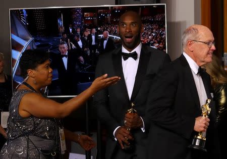 90th Academy Awards - Oscars Backstage - Hollywood, California, U.S., 04/03/2018 - Best animated short film - Kobe Bryant reacts while being directed to the photo stage with Glen Keane after winning the Best Short Film (Animated) Award for "Dear Basketball". REUTERS/Mike Blake