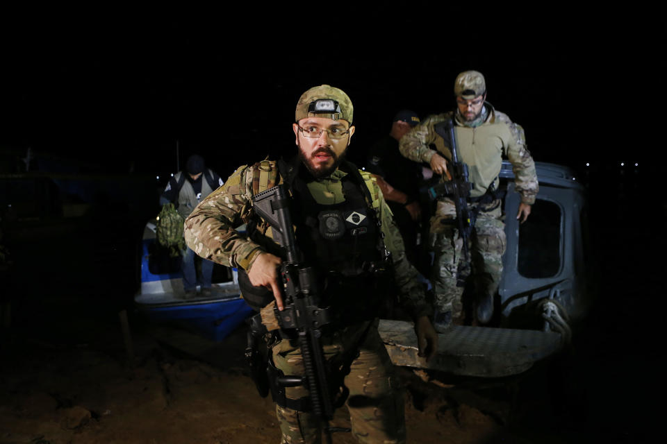 Federal police officers arrive at the pier after recovering human remains found during a search for Indigenous expert Bruno Pereira of Brazil and freelance reporter Dom Phillips of Britain, in Atalaia do Norte, Amazonas state, Brazil, Wednesday, June 15, 2022. A federal police investigator said a suspect confessed to fatally shooting Pereira and Phillips in a remote part of the Amazon and took officers to where the bodies were buried. (AP Photo/Edmar Barros)