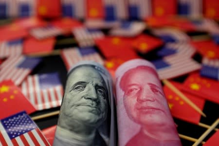 FILE PHOTO: Illustration picture showing U.S. dollar and China's yuan banknotes