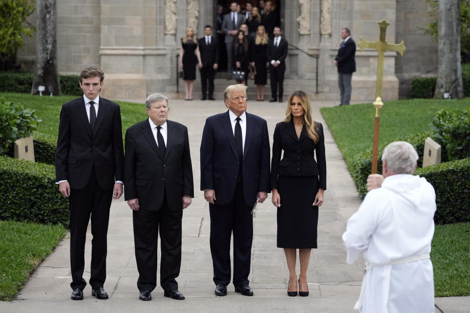 Former President Donald Trump, center, stands with his wife Melania, second right, their son Barron, left, and father-in-law Viktor Knavs, second left, at the end of the funeral for the former first lady's mother Amalija Knavs, Thursday, Jan. 18, 2024, at the Church of Bethesda-by-the-Sea in Palm Beach, Fla.,. (AP Photo/Rebecca Blackwell)
