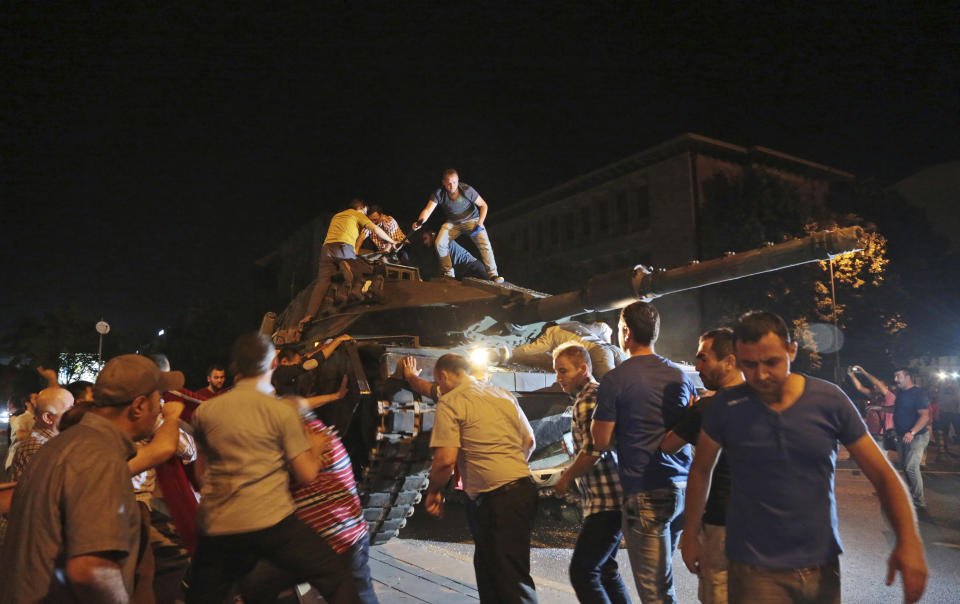 FILE - A tank moves into position as Turkish people attempt to stop it, in Ankara, Turkey, on July 15, 2016. (AP Photo/Burhan Ozbilici, File)