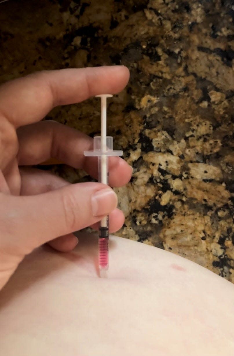 Kelly Swayze, 34, of Trenton, injects a dose of a obesity management medication containing semaglutide, which is the active ingredient in Wegovy. The medicine, she hopes, will help her lose weight and stave off diabetes.