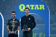 Tennis - ATP - Qatar Open - Khalifa International Tennis and Squash Complex, Doha, Qatar - January 5, 2019 Spain's Roberto Bautista Agut and Czech Republic's Tomas Berdych celebrate with their trophies after Roberto Bautista Agut wins the final REUTERS/Ibraheem Al Omari