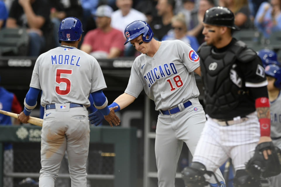 Chicago Cubs' Christopher Morel (5) celebrates with teammate Frank Schwindel (18) at home plate after scoring on a Patrick Wisdom double during the first inning of a baseball game against the Chicago White Sox at Guaranteed Rate Field, Saturday, May 28, 2022, in Chicago. (AP Photo/Paul Beaty)