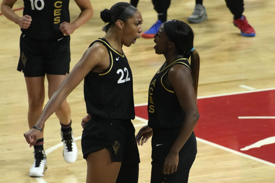 Las Vegas Aces forward A'ja Wilson, left, and guard Jackie Young celebrates after a play against the New York Liberty during the first half in Game 2 of a WNBA basketball final playoff series Wednesday, Oct. 11, 2023, in Las Vegas. (AP Photo/John Locher)