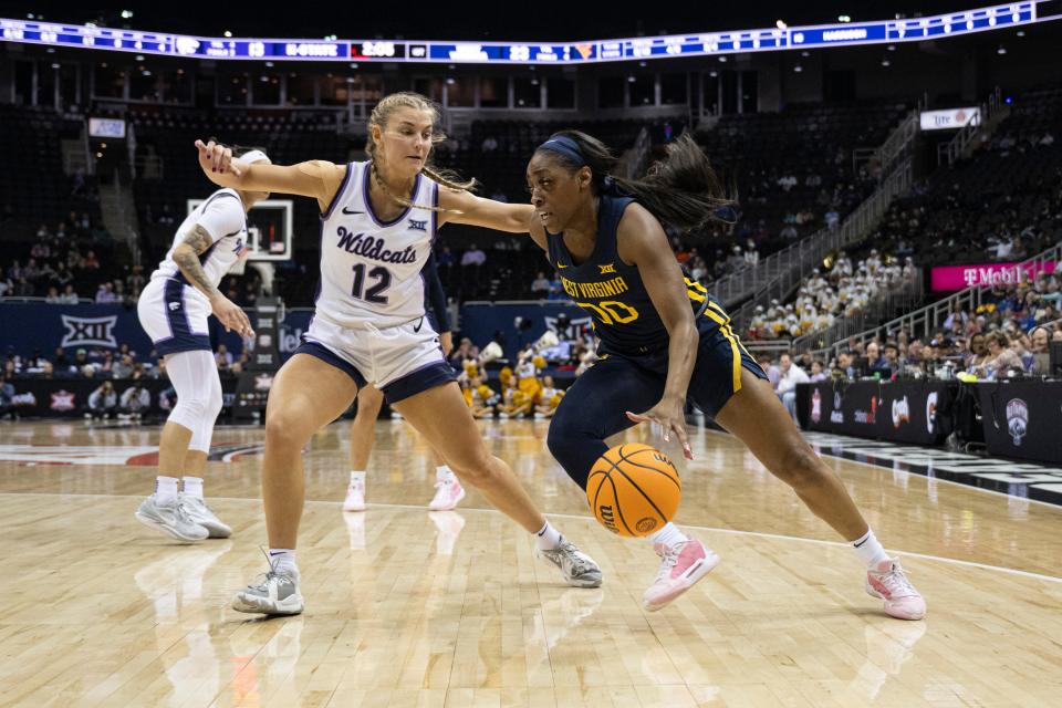 Kansas State guard Gabby Gregory (12) defends against West Virginia's Jayla Hemingway (00) during the Big 12 Tournament quarterfinal game on March 9 at T-Mobile Center in Kansas City, Mo.