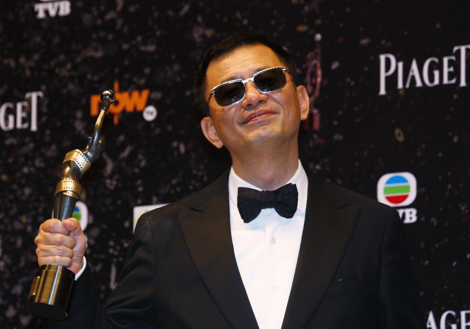 Hong Kong director Wong Kar-wai poses after winning the Best Director award for his movie “The Grandmaster” in the 33rd Hong Kong Film Awards in Hong Kong Sunday, April 13, 2014. (AP Photo/Kin Cheung)