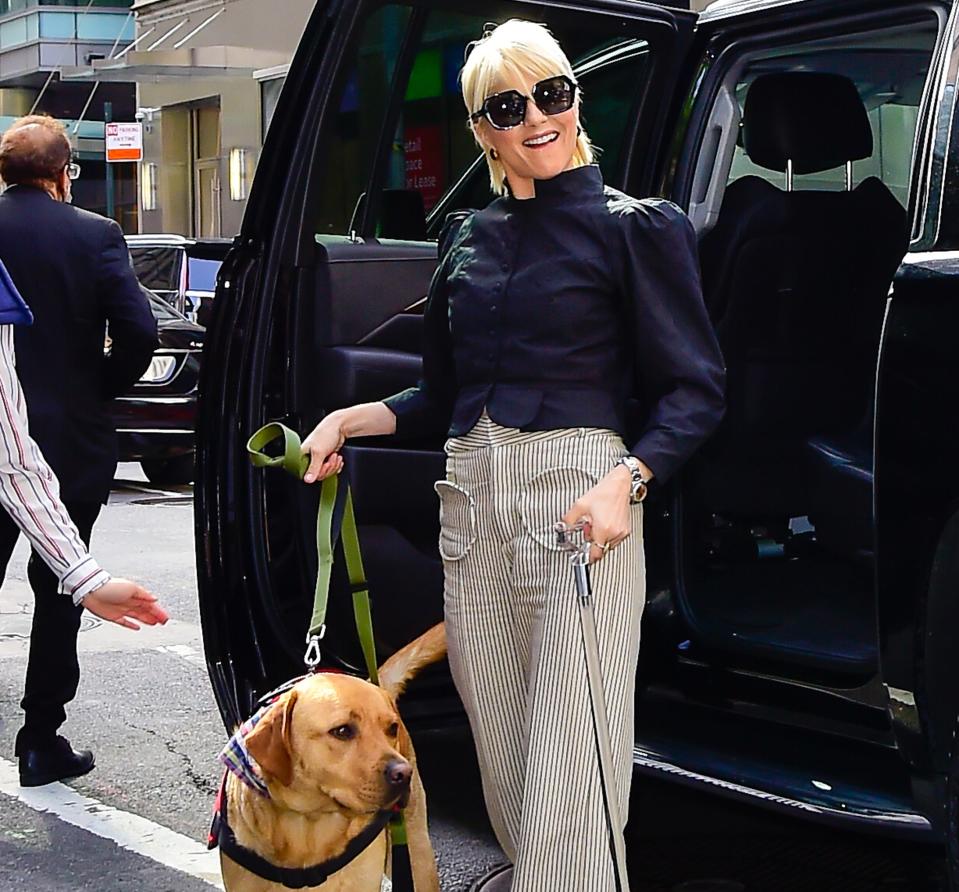 Selma with guide dog exiting a vehicle