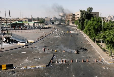 A man is seen on the street during a curfew, three days after the nationwide anti-government protests turned violent, in Baghdad