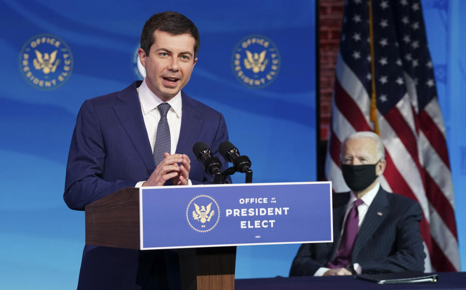 Former South Bend, Ind. Mayor Pete Buttigieg, President-elect Joe Biden's nominee to be transportation secretary reacts to his nomination as Biden looks on during a news conference at The Queen theater in Wilmington, Del., on Dec. 16, 2020. (Kevin Lamarque/Pool via AP)