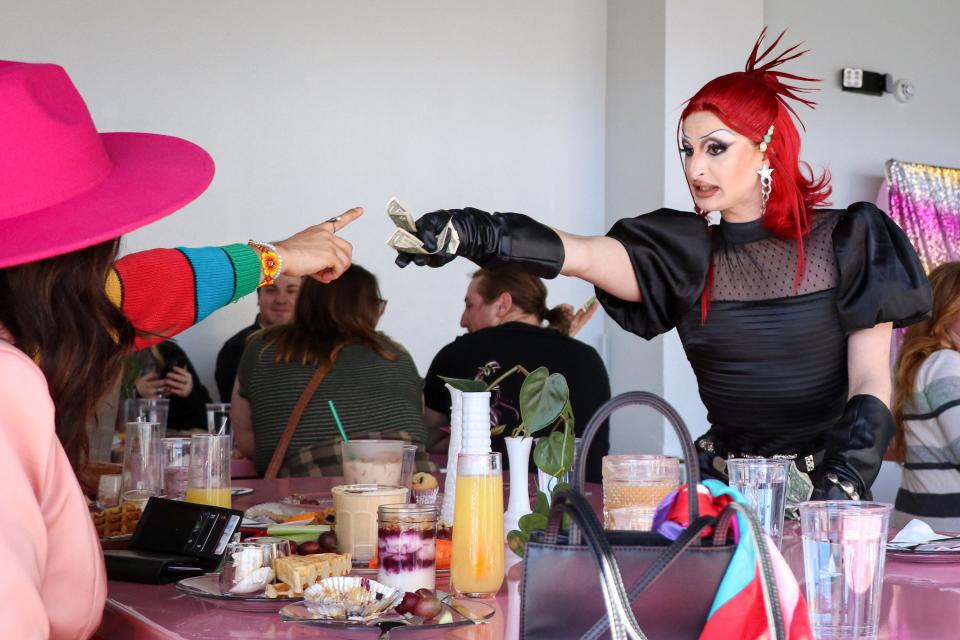 Springfield drag queen Jimmy Anti reaches for a tip during the Green House Coffee and Affogato Bar Drag Brunch Saturday, Jan. 29, 2022. Anti began performing drag over four years ago in Springfield.