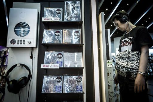 A customer listens to a CD in a music shop in Hong Kong. China has seen an estimated 99% digital piracy rate in recent years, meaning the legitimate market has operated at only a fraction of its true potential, according to the IFPI