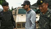 Thai police escort a suspect (C) after he was arrested on the Thai side of the Cambodian border on September 1, 2015 in connection with a bomb attack in Bangkok