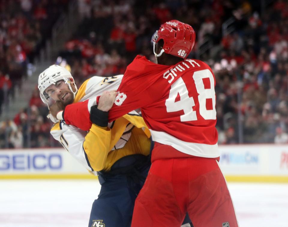 Detroit Red Wings left wing Givani Smith (48) fights with Nashville Predators defenseman Ben Harpur (17) during second period action Tuesday, December 7, 2021, at Little Caesars Arena. 