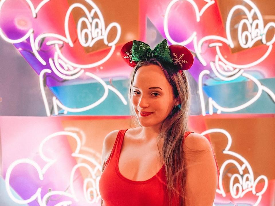 jenna posing with the light-up mickey wall at disney's contemporary resort 