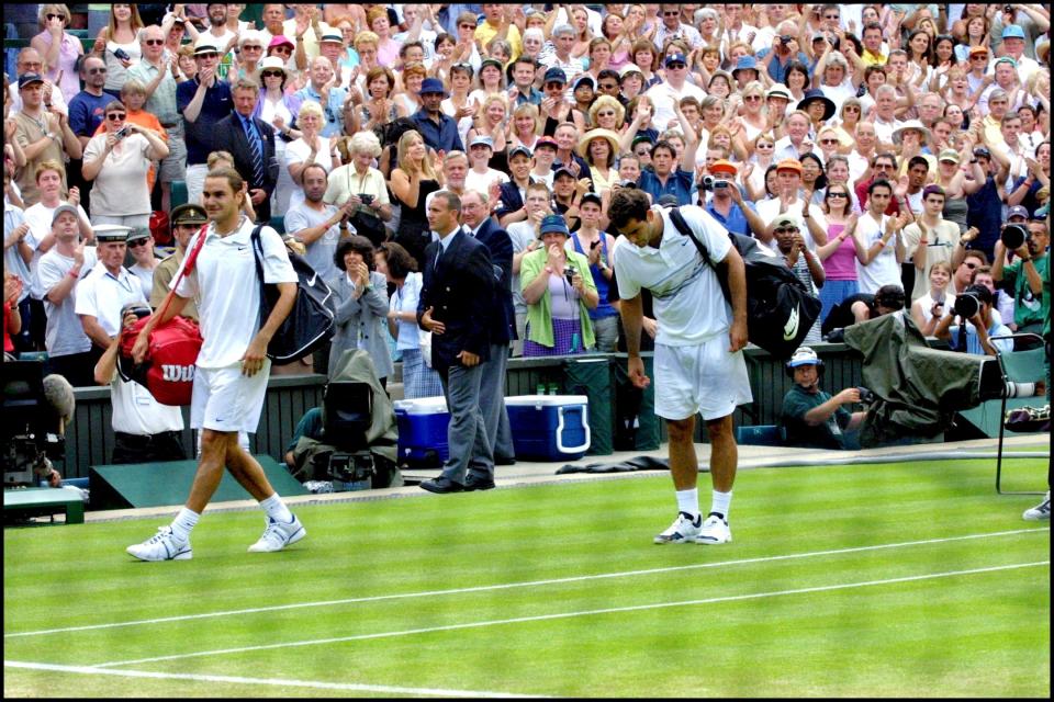 Roger Federer (pictured left) smiles after defeating Pete Sampras (pictured right) at Wimbledon in 2009.