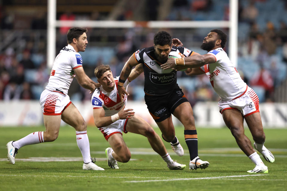 WOLLONGONG, AUSTRALIA - JULY 20: Isaiah Papali’i of the Tigers is tackled by Zac Lomax, Ben Hunt and Mikaele Ravalawa of the Dragons  during the round 21 NRL match between St George Illawarra Dragons and Wests Tigers at WIN Stadium on July 20, 2023 in Wollongong, Australia. (Photo by Jeremy Ng/Getty Images)