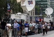 Members of the media wait for New England Patriots quarterback Tom Brady to arrive outside 345 Park Avenue, which houses the National Football League (NFL) headquarters offices, in the Manhattan borough of New York City, June 23, 2015. Brady's appeal of his four-game NFL suspension for participating in a scheme to deflate footballs during last season's playoffs begins Tuesday at NFL headquarters in New York. REUTERS/Mike Segar