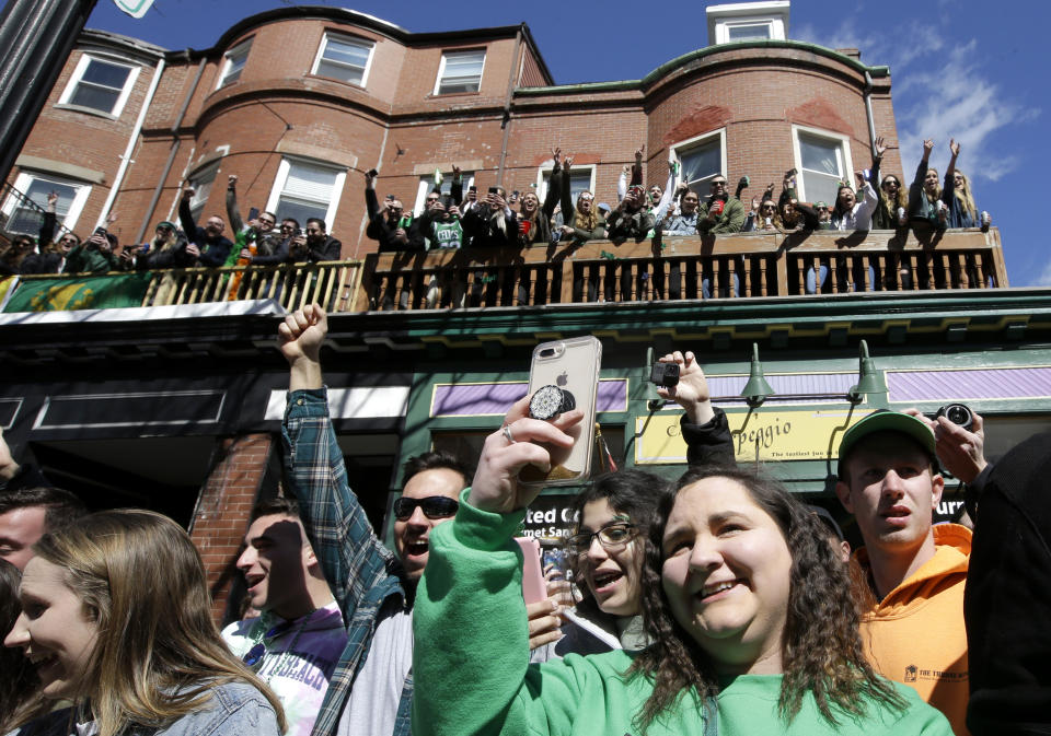 Spectators cheer during the annual St. Patrick's Day parade, Sunday, March 17, 2019, in Boston's South Boston neighborhood. The city celebrated the holiday with crowds lining the route of the 118th edition of the parade. (AP Photo/Steven Senne)