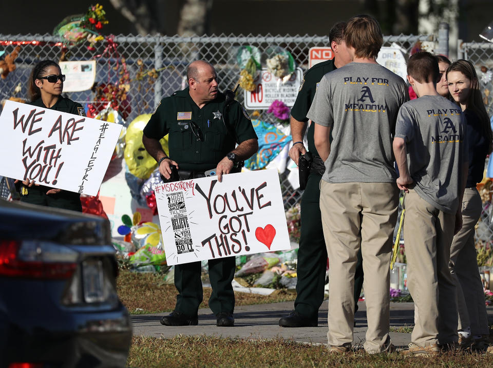 Broward County Sheriff officers welcome students as they arrive.