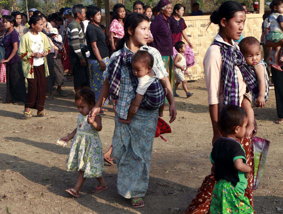 In this Feb. 22, 2012, photo, refugee women with children gather in their refugee camp in Myitkyina, Kachin state, northern Myanmar. A human rights group says the governments in Myanmar and China are failing to stop the brutal trafficking of young women from the conflict-ridden Kachin region for sexual slavery. (AP Photo/Khin Maung Win, File)