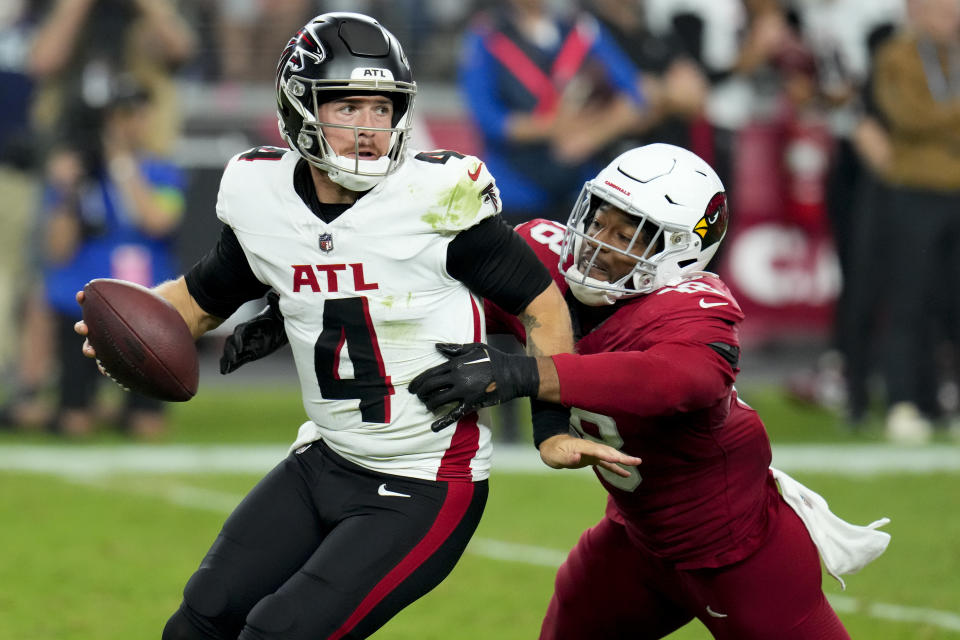 Arizona Cardinals linebacker BJ Ojulari (18) sacks Atlanta Falcons quarterback Taylor Heinicke (4) during the second half of an NFL football game, Sunday, Nov. 12, 2023, in Glendale, Ariz. (AP Photo/Ross D. Franklin)