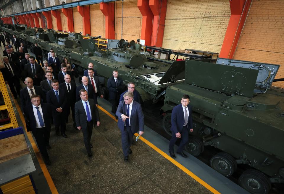 FILE - Deputy head of Russia's Security Council Dmitry Medvedev, accompanied by Kurganmashzavod Executive Director Pyotr Tyukov, visits the Kurganmashzavod also known for its BMP series of infantry fighting vehicles, in Kurgan, Russia, Nov. 11, 2022. President Vladimir Putin is likely to win another six-year term easily in an election expected in March, using his sweeping grip on Russia’s political scene to extend his tenure of over two decades in power. But he faces daunting challenges. (Ekaterina Shtukina/Sputnik Pool Photo via AP, File)