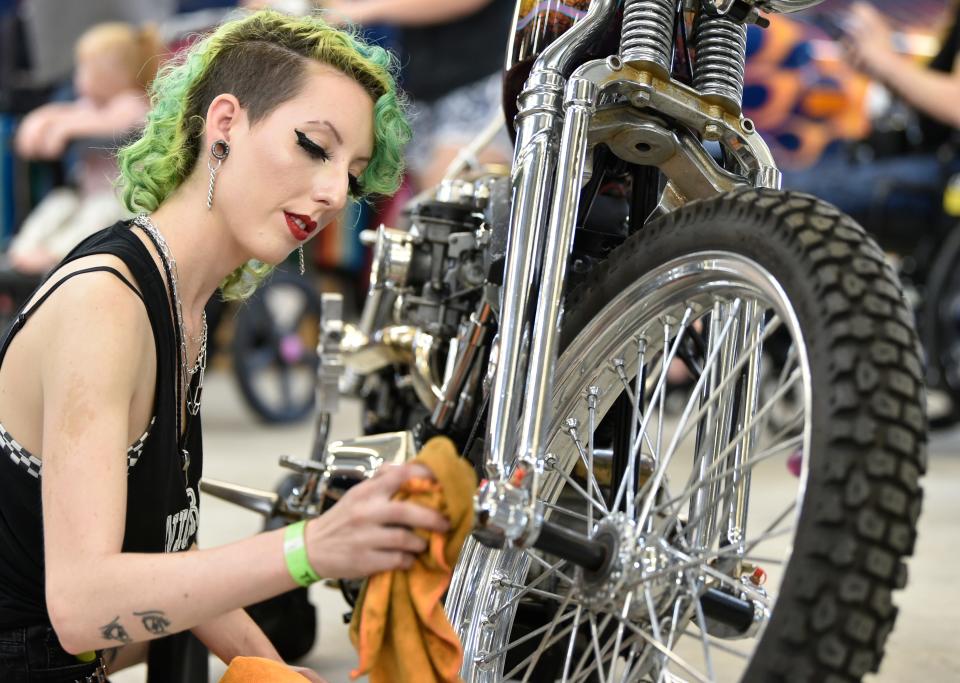 Alyssa Vinney of Orlando wipes down a 1974 Shovelhead Harley Davidson at last year's Thunder by the Bay Music & Motorcycle Festival. Thunder Alley will return to the 26th annual festival in February.