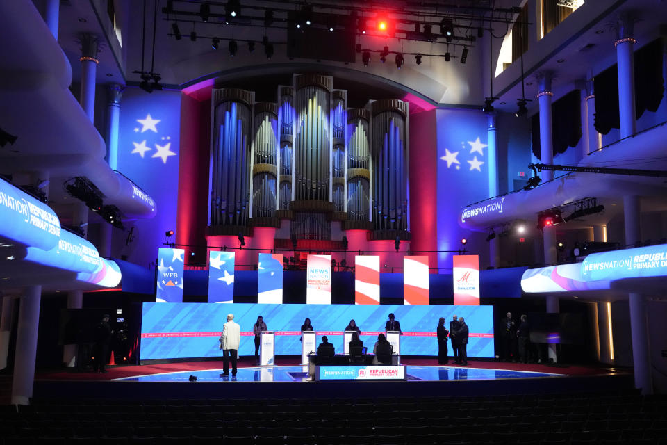 Stand-ins assume positions of candidates and moderators to check sound and lighting, in advance of a Republican presidential primary debate hosted by NewsNation on Wednesday, Dec. 6, 2023, at the Moody Music Hall at the University of Alabama in Tuscaloosa, Ala. (AP Photo/Gerald Herbert)