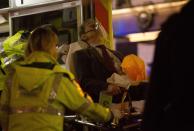 A man receives medical attention after part of the ceiling at the Apollo Theatre on Shaftesbury Avenue collapsed in central London December 19, 2013. Emergency services said nearly 90 people had been injured in a packed Londontheatre on Thursday when part of the ceiling collapsed during a performance, bringing the city's West End theatre district to a standstill.The audience was showered with masonry and debris following the incident at the Apollo Theatre, where about 720 people including many families were watching the hugely popular play "The Curious Incident of the Dog in the Night-Time". REUTERS/Neil Hall (BRITAIN - Tags: DISASTER ENTERTAINMENT)