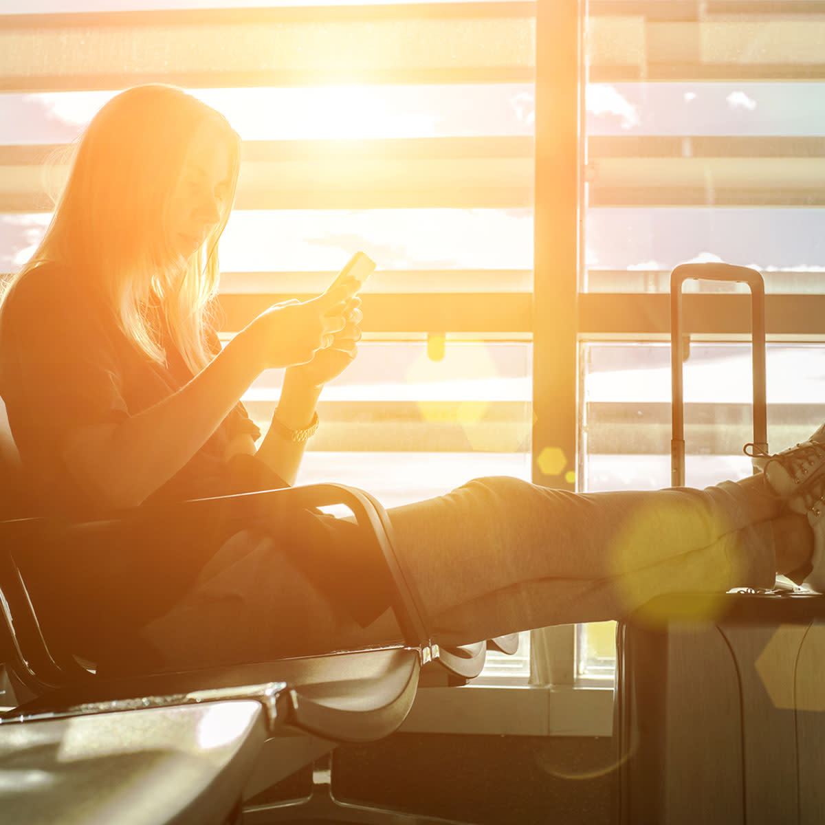 young-woman-texting-airport