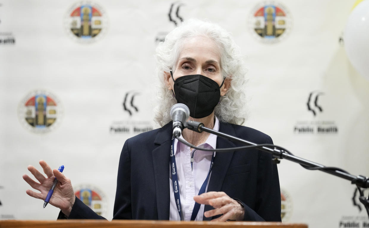 Dr. Barbara Ferrer, wearing a black mask, at the microphone.