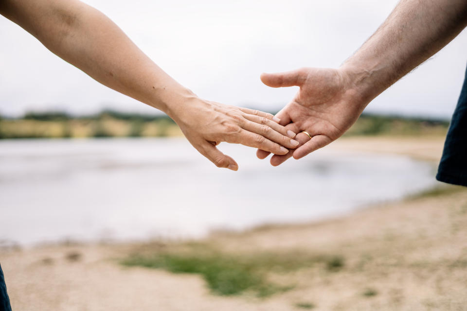 hands reaching out to hold each other