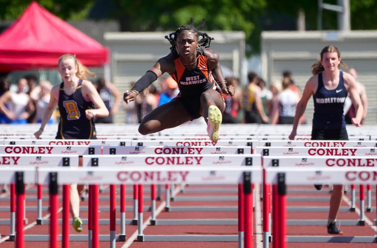 Lisa Raye of West Warwick wins her heat and then takes first place in the hurdles final, helping the Wizards to the state championship.